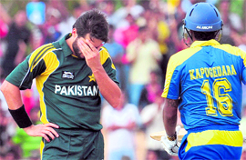 Pakistans Shahid Afridi (L) gestures as Sri Lankas Chamara Kapugedara takes a run during the second ODI at The Rangiri Dambulla International stadium on Saturday.