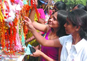 FOR MY BROTHER: Girls select rakhis at Sewa Mahila Bazaar a few days before the Raksha Bandhan festival in New Delhi