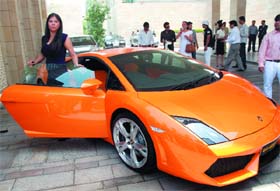 MAIDEN JOURNEY: A Lamborghini car owner poses with her car during the first women car driving event, in New Delhi