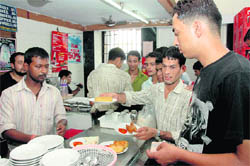 People grab a bite at Buffet Snacks Parlour in Dehradun.