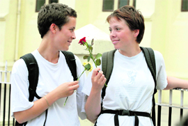 Two foreign tourists wishing each other with flowers on the Friendship Day in Shimla on Sunday.