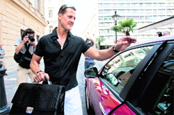 Former seven-time F1 world champion Michael Schumacher gets into his car after visiting Ferraris Felipe Massa at Honved Hospital in Budapest on Saturday.