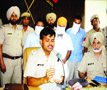 SSP Rakesh Aggarwal shows fake currency notes at a press conference in Nawanshahr on Monday.
