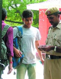 Students of Ramjas College being interrogated by security personnel after a clash between two groups over a poster in the college in New Delhi