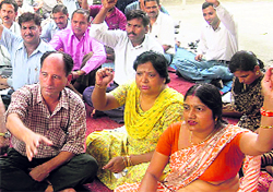 Collectorate employees protest outside their office in Dehradun on Tuesday.