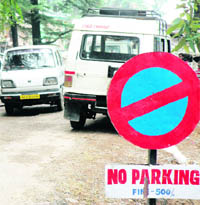 Commercial vehicles parked on the road at Mcleodganj despite a warning.