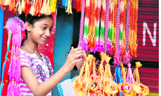 A girl selects a rakhi to celebrate Raksha Bandhan in Jammu.