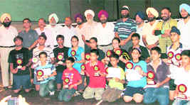 Winners of Ludhiana Badminton Championship strike a pose on Tuesday.