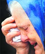 A Croatian Serb woman cries during a memorial service in Belgrade