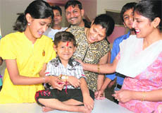 Sasha from Pakistan ties a rakhi on the wrist of Vaibhav from Panchkula at Sood Bhawan in Chandigarh on Wednesday.