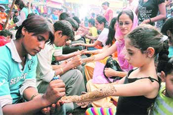 Girls get mehndi applied on their hands on Rakhi in Dehradun
