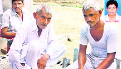 Ombir (right), father of the victim, Anil, outside his house; and (inset)