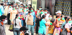 People wait to get tested for swine flu outside a Pune hospital on Wednesday.