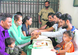 kin of Borstal Jail inmates share the sacred moment in Ludhiana on Wednesday. 