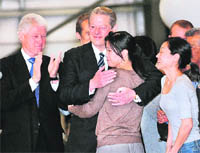 Journalist Laura Ling hugs former US Vice President Al Gore as ex-President Bill Clinton looks on in California on Wednesday. 