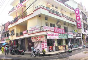 A guesthouse named after Holiday Inn at Burail. Also a country liquor shop on its ground floor