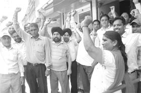 Members of the Bank Employees Federation stage a protest in front of Uco Bank in Patiala