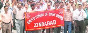 Bank employees take out a rally in support of their demands in Dehradun on Thursday.
