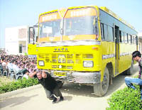 SK Chaudhary pulls a school bus with his hair in Nivedita Senior Secondary School at Ellenabad in Sirsa district. 
