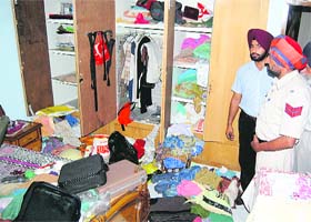 Cop checks the ransacked house of Surinder Mohan Sehgal in Kitchlu Nagar