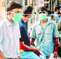 Persons with protective masks outside Ram Manohar Lohia Hospital in New Delhi.