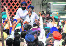 Shiromani Akali Dal president Sukhbir Singh Badal is offered sweets by a supporter after he won Jalalabad Assembly seat on Thursday. 