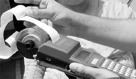 An on-the-spot billing machine being used to issue an electricity bill in Mohali.