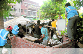 The MC staff remove tents put up by cops in Sector 42, Chandigarh, on Friday.