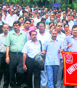 Striking bank employees take out a rally in Dehradun on Friday.