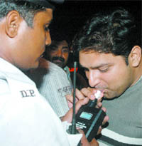A Delhi traffic policeman checks a man during a surprise drive against drunken driving in New Delhi on Friday night.