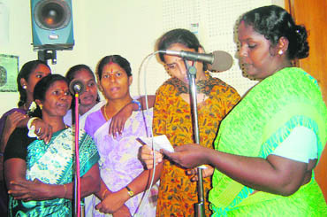 Jamila along with other community women recording a 