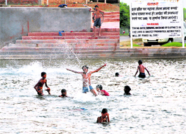 Not giving two hoots to the norms of the Chandigarh Administration, boys take a bath at the Sector 42 artificial lake.