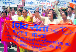 Shiv Sena activists holds a protest at the Clock Tower in Dehradun on Sunday.