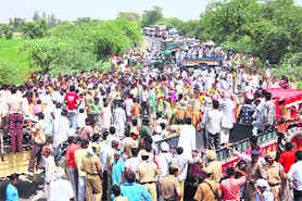 Villagers block traffic near Khairkan village on the national highway in Sirsa on Sunday.