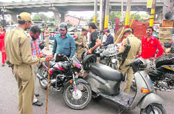 The police checks documents of vehicles in Jammu on Sunday in view of the tight security for impending Independence Day. 