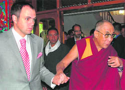 Jammu and Kashmir Chief Minister Omar Abdullah escorts Tibetan spiritual leader Dalai Lama on the latters arrival at Bakula Airport, Leh, on Sunday.