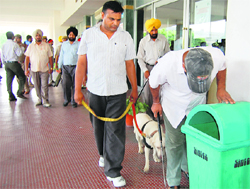 Dog squad checks a garbage bin at DMC Hero Heart Hospital in Ludhiana on Sunday.