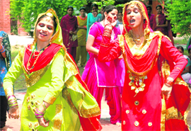 Girls celebrate Teej at GTB College in Dakha.