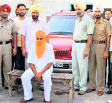 The accused in police custody in Raikot on Sunday. 