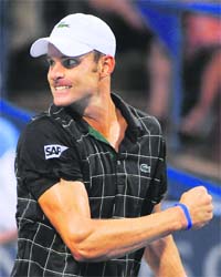 Andy Roddick pumps his fist after winning a game against John Isner during their semifinal match at the Legg Mason Tennis Classic in Washington