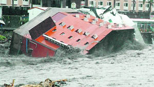 Taiwan's government mobilised troops on Sunday to rescue tens of thousands of residents trapped in the island's worst flooding in 50 years, which left one person dead and at least 29 missing, officials said. Typhoon Morakot pounded Taiwan over the weekend with powerful winds and torrential rain. The number of people listed as missing and feared dead went up from eight to 29, the government's National Fire Agency said.