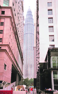 Workers walk out during a lunch break at a newly constructed building near the iconic Malaysian landmark Patronas Twin Towers in Kuala Lumpur on Monday. A Nobel prize-winning economist Paul Krugman said in a speech to an international business forum in Kuala Lumpur that the world has avoided a "Great Depression 2.0" but it will take at least two years for the global economy to make a full recovery.