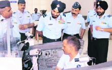 Air Vice-Marshal Satish Pal Singh (centre), Senior Officer-in-Charge (Administration), Training Command, inspects a simulator during his visit to the Air Force Station in Chandigarh on Monday.