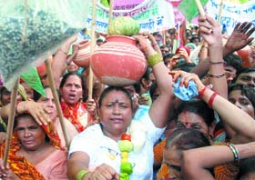 LJP activists shout slogans during a demonstration against the price hike of essential commodities in New Delhi