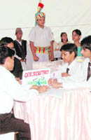 Children take part in the Mock Parliament in Dehradun on Monday.
