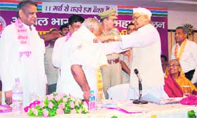 Haryana Governor Jagannath Pahadia honours a member of the Vaish community in Gurgaon