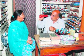 Dr Randhir Singh examines a patient in his dispensary