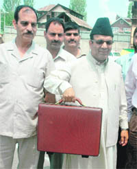 Finance Minister Abdul Rahim Rather poses for photographers as he arrives at the Assembly in Srinagar to present the 2009-10 Budget on Monday.