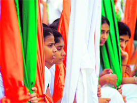 Schoolgirls take a break during the rehearsal for Independence Day celebrations in Ludhiana on Monday.