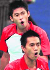 Indonesias Rian Sukmawan (L) and teammate Yonathan Suryatama react after missing a point against against Chinas Chai Biao and Liu Xiaolong during the mens doubles first round badminton match of the World Badminton Championship in Hyderabad